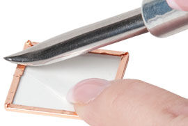 Foil being pressed with burnisher